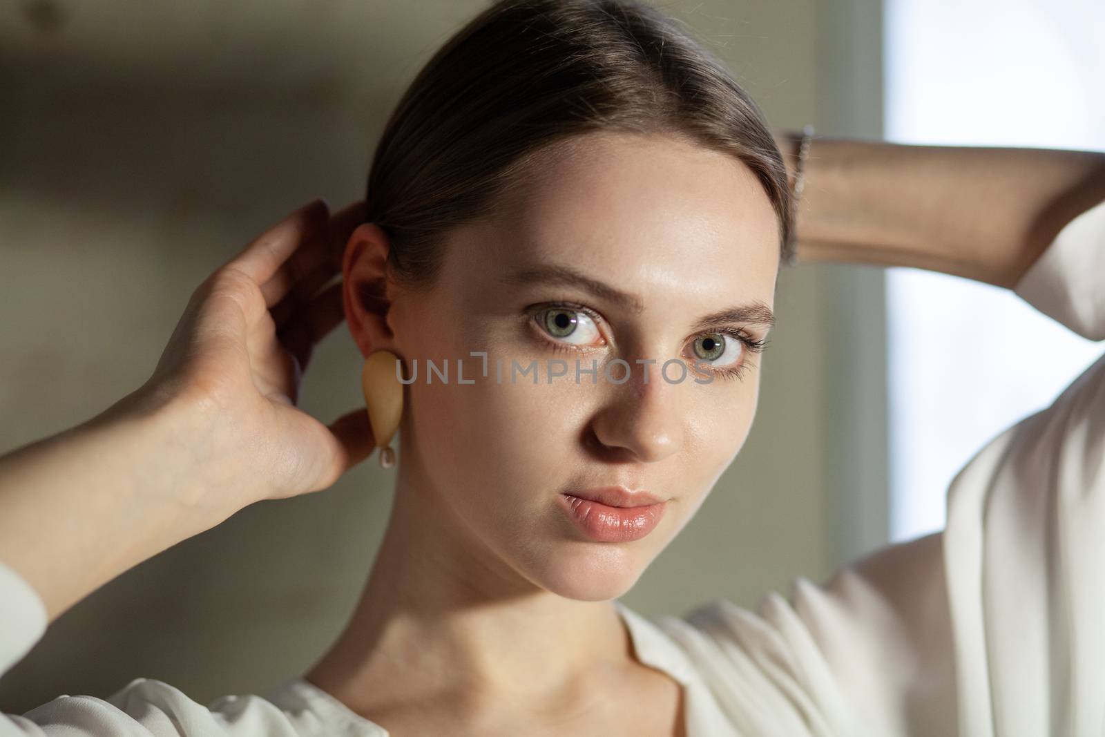 Portrait of beautiful fair young woman with fashion jewelry, one light source