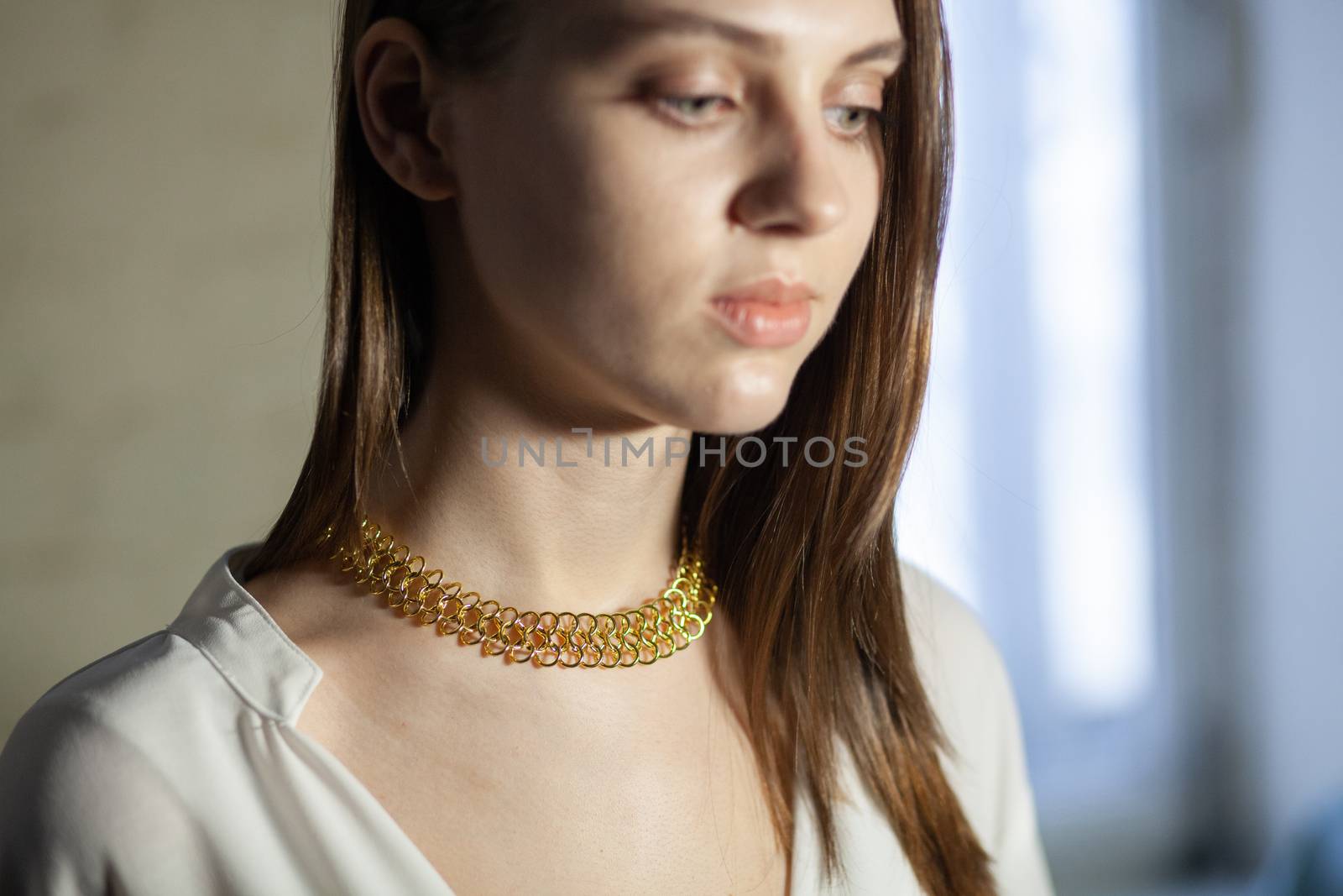 Portrait of beautiful fair young woman with fashion jewelry, one light source