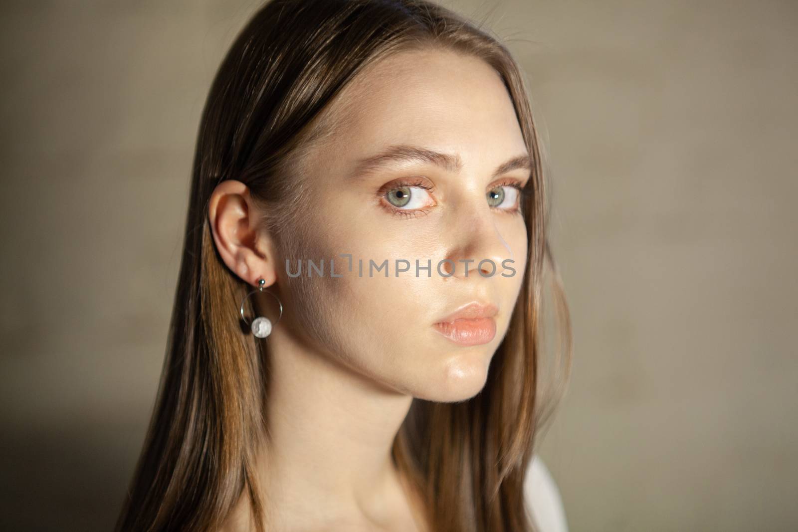 Portrait of beautiful fair young woman with fashion jewelry, one light source