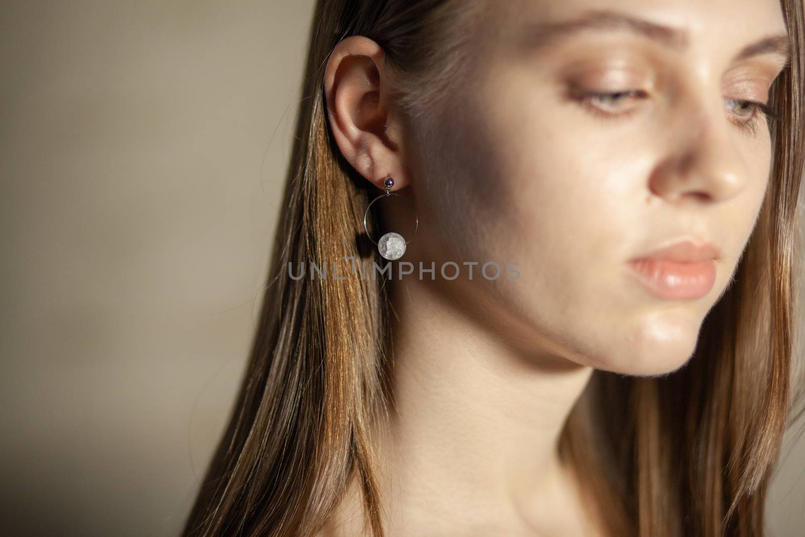 Portrait of beautiful fair young woman with fashion jewelry, one light source