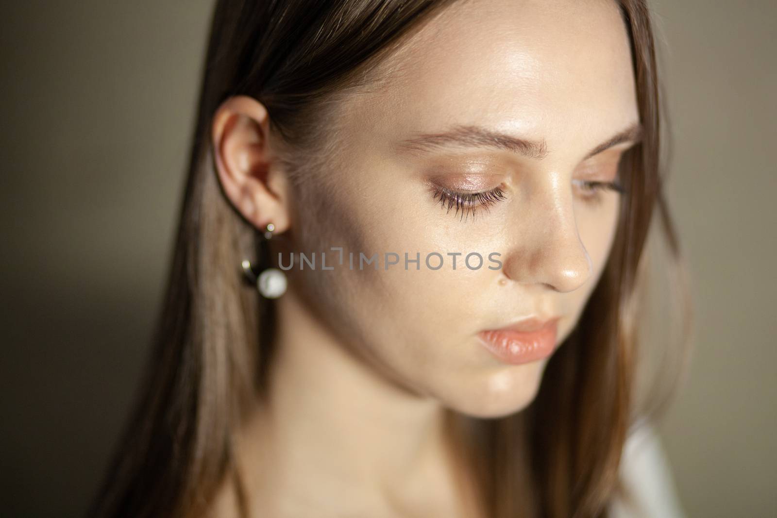 Portrait of beautiful fair young woman with fashion jewelry, one light source