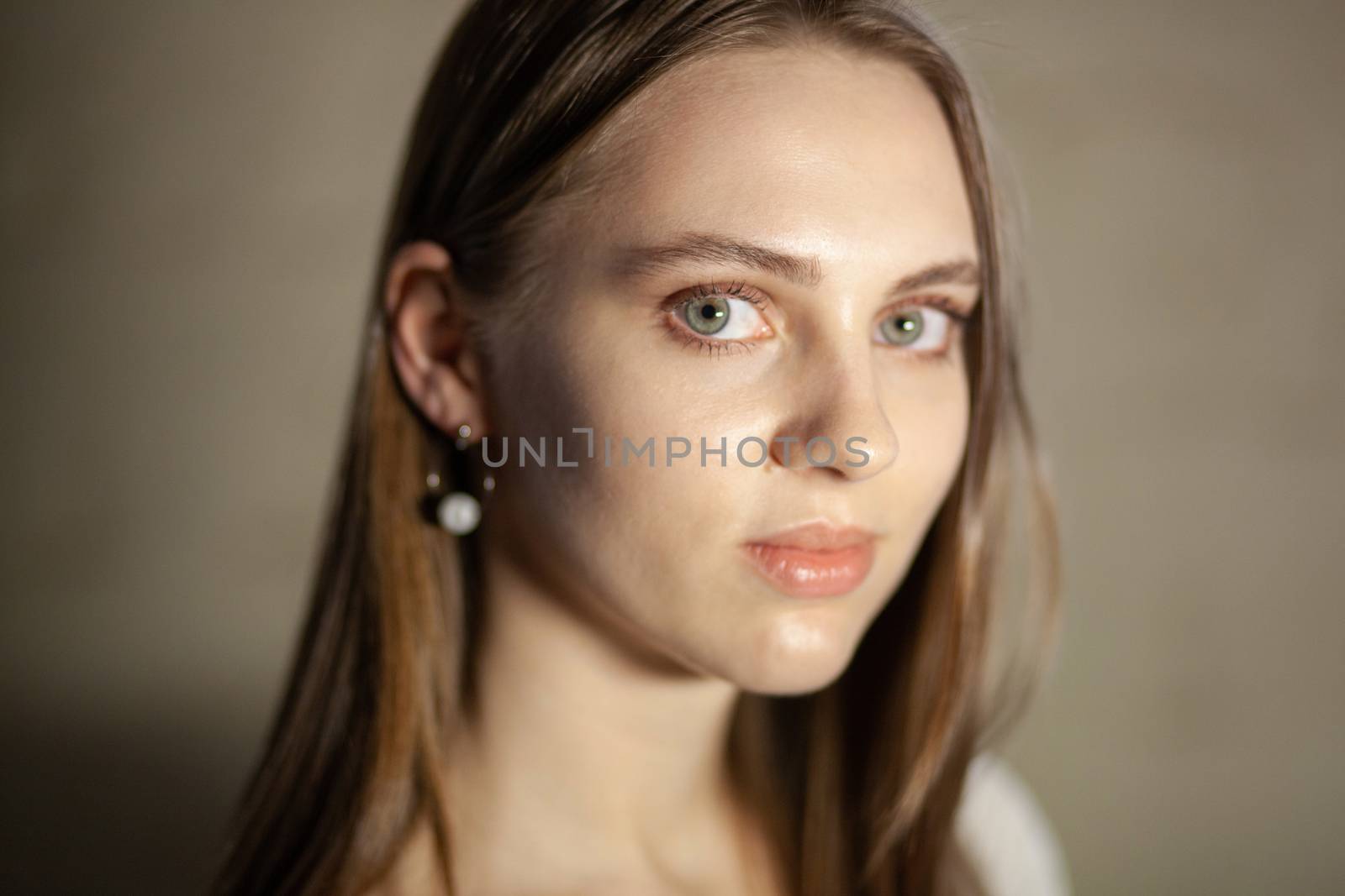 Portrait of beautiful fair young woman with fashion jewelry, one light source
