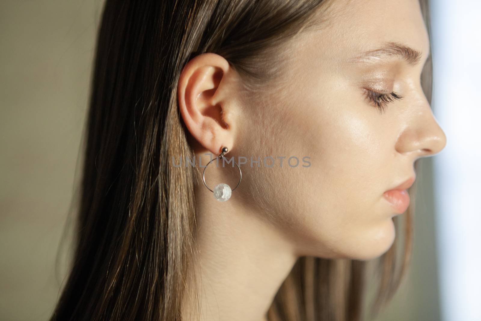Portrait of beautiful fair young woman with fashion jewelry, one light source