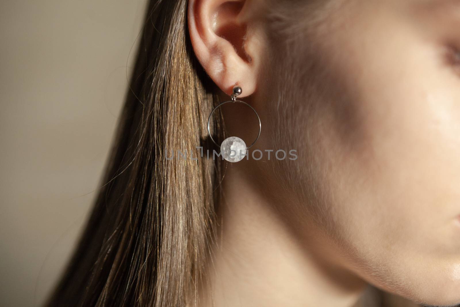 Portrait of beautiful fair young woman with fashion jewelry, one light source