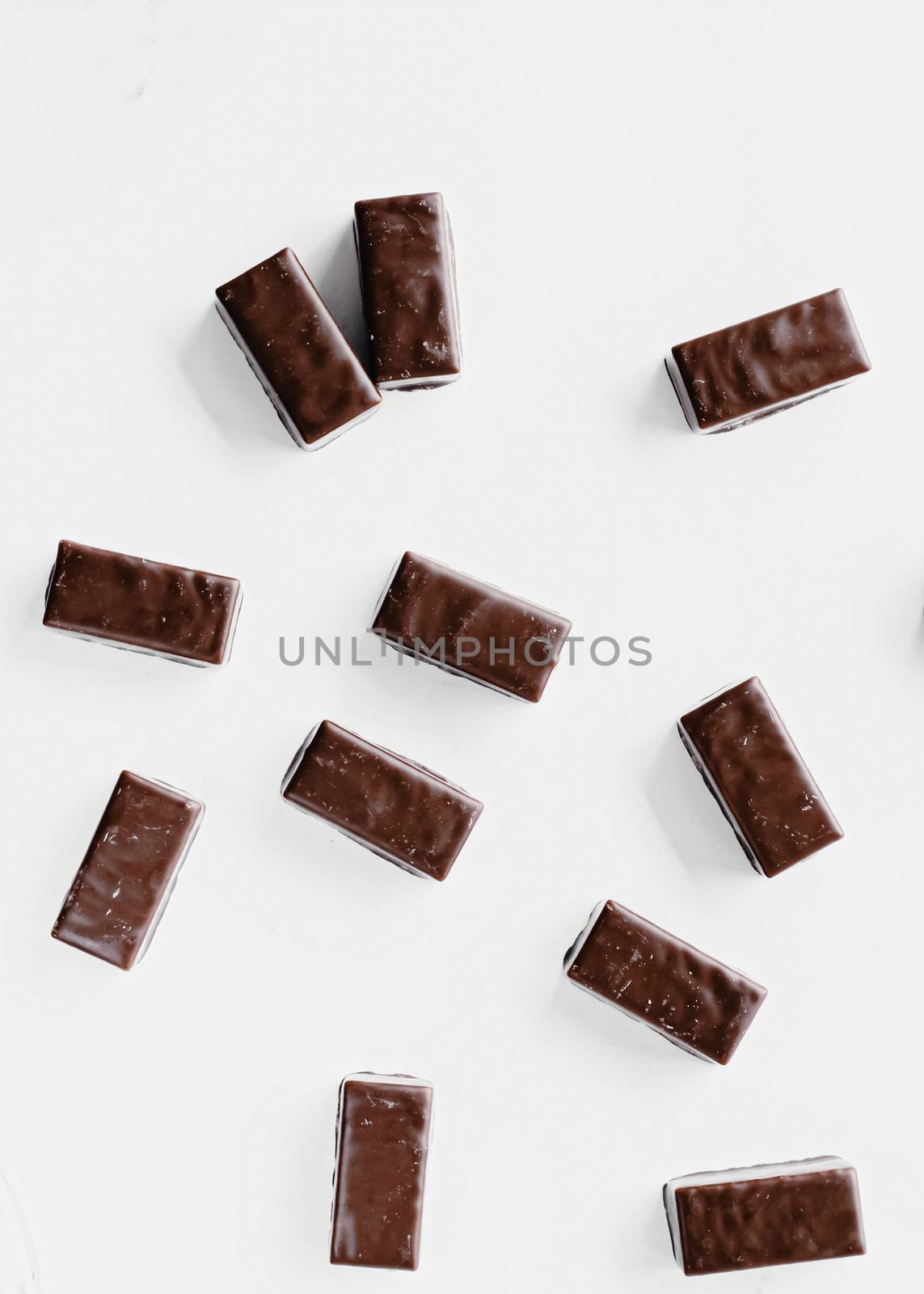 Dark chocolate candies isolated on white background, sweet food and dessert by Anneleven