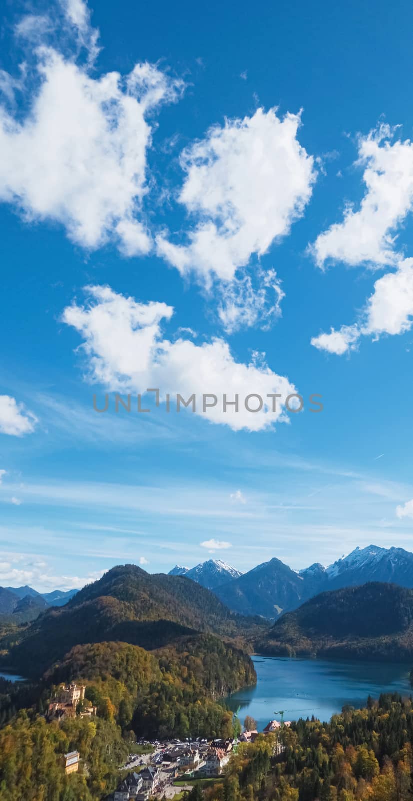 Beautiful nature of European Alps, landscape view of alpine mountains, lake and village on a sunny day, travel and destination by Anneleven