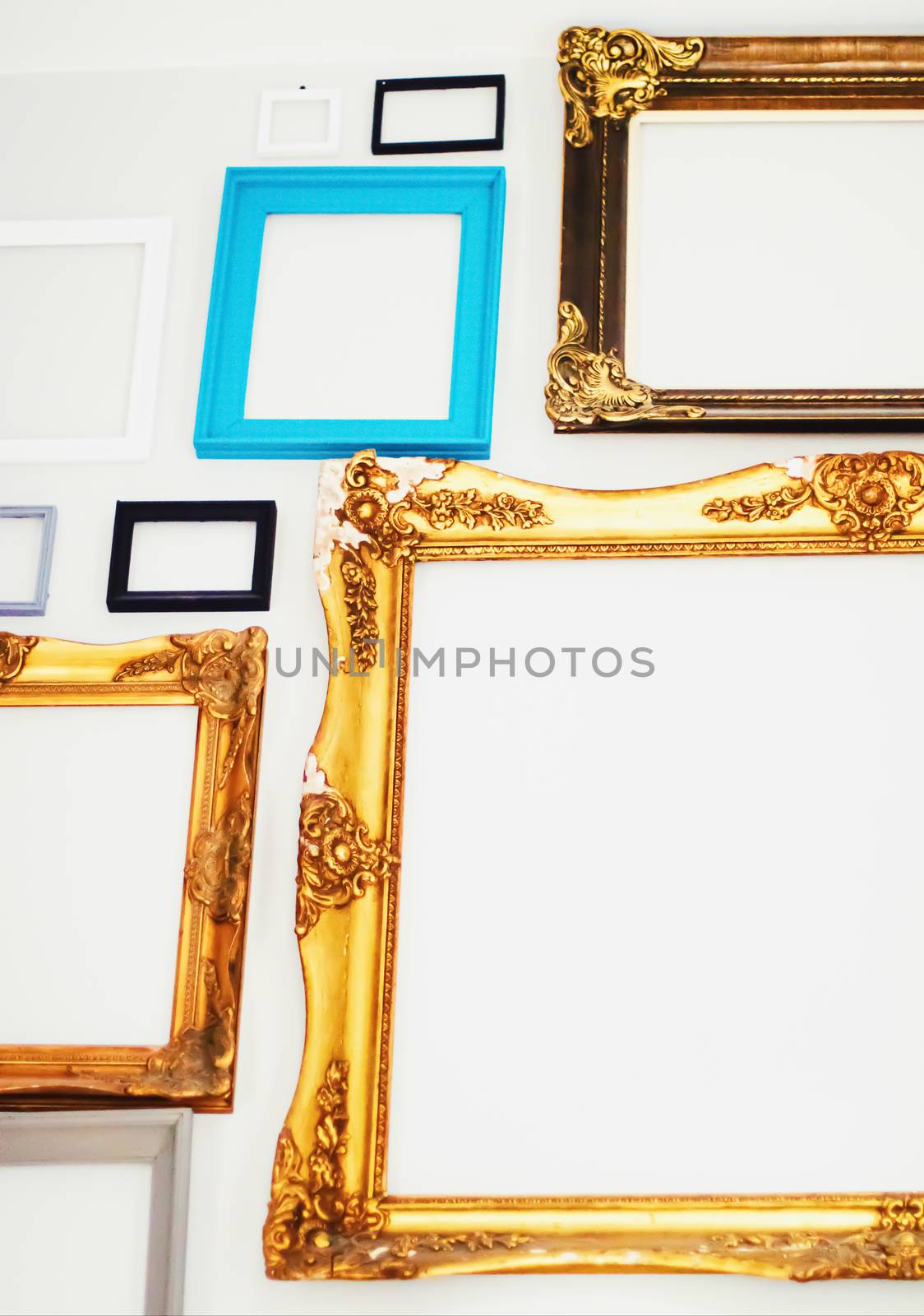 Empty art frames on gallery wall, decor and design details