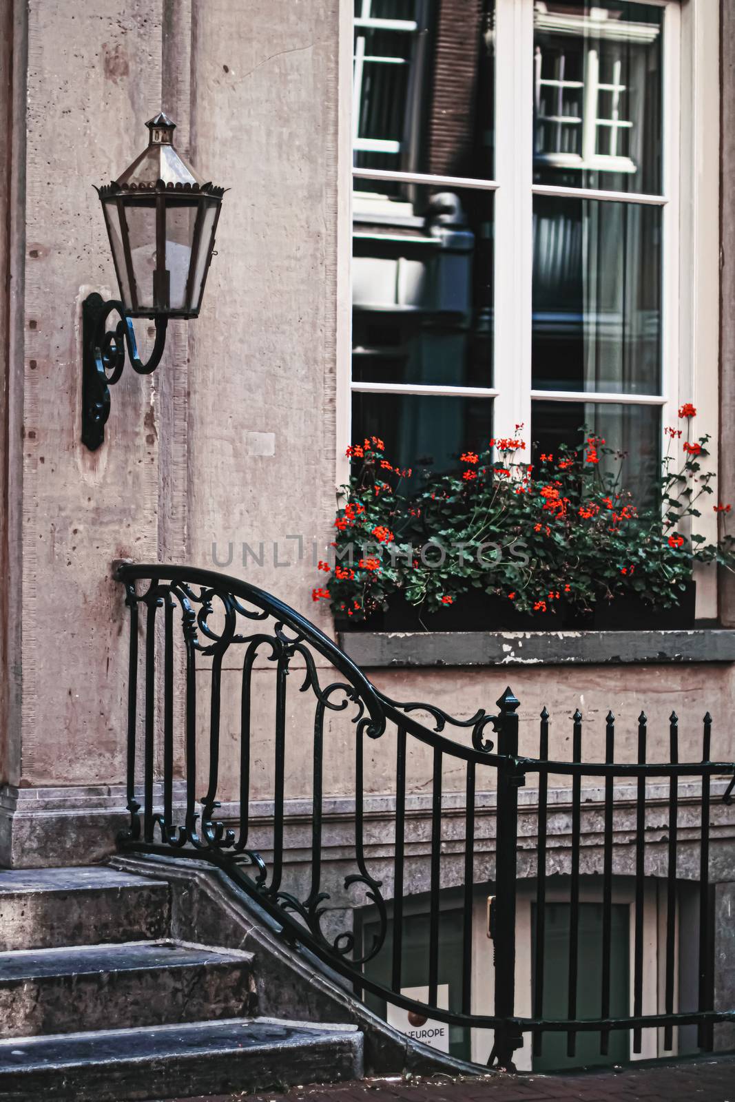 Architectural detail of a building on the main city center street of Amsterdam in Netherlands by Anneleven