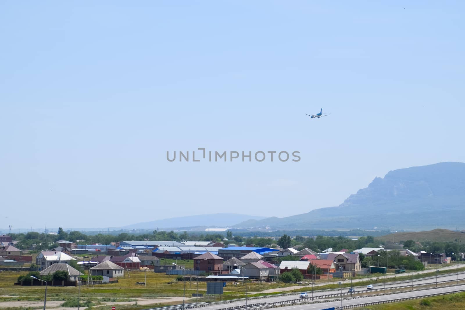 The plane lands over the settlement and the track.