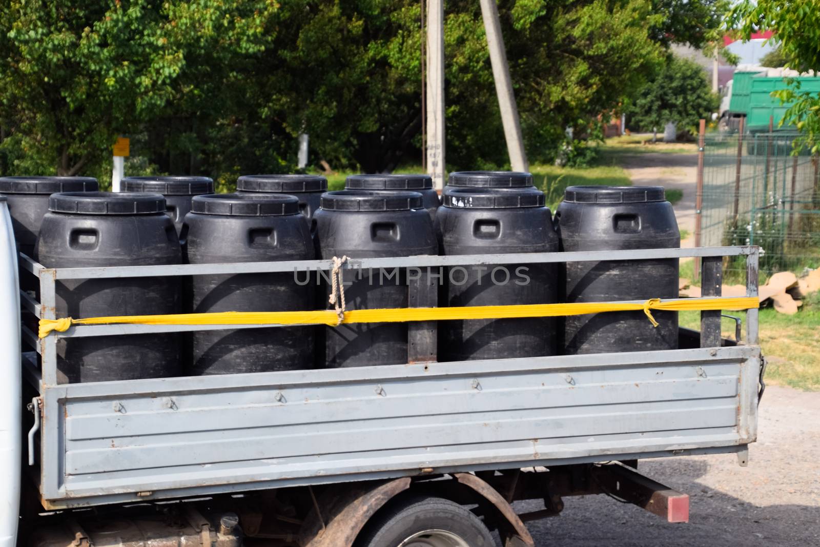 Transportation of chemical agents in plastic barrels on a truck.