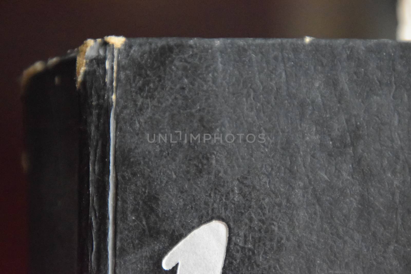 The binding of an old book in black cover.