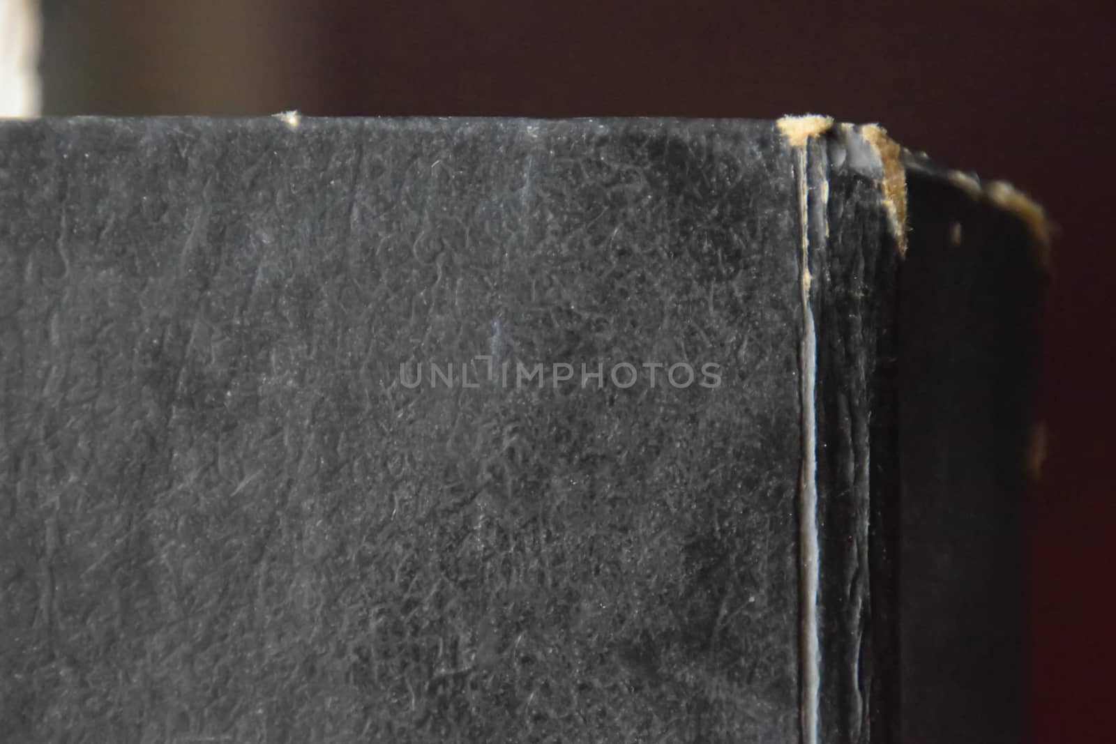 The binding of an old book in black cover.