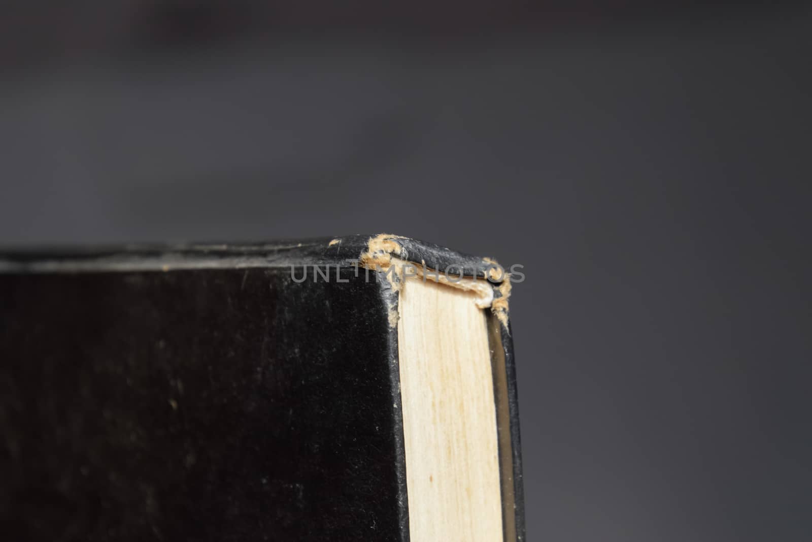 The binding of an old book in black cover.