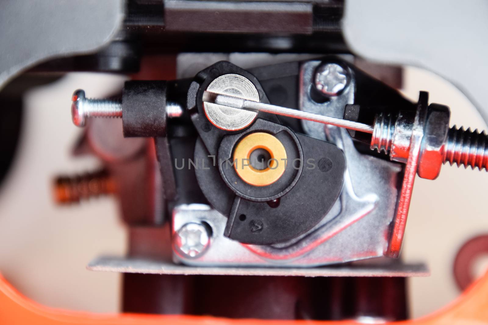Elements of the fuel system of a gasoline trimmer. Fuel tank and carburetor trimmer engine. Fuel system of a carburetor two-stroke engine. Trimer gascosis with a leaf for mowing grass and shrubs.