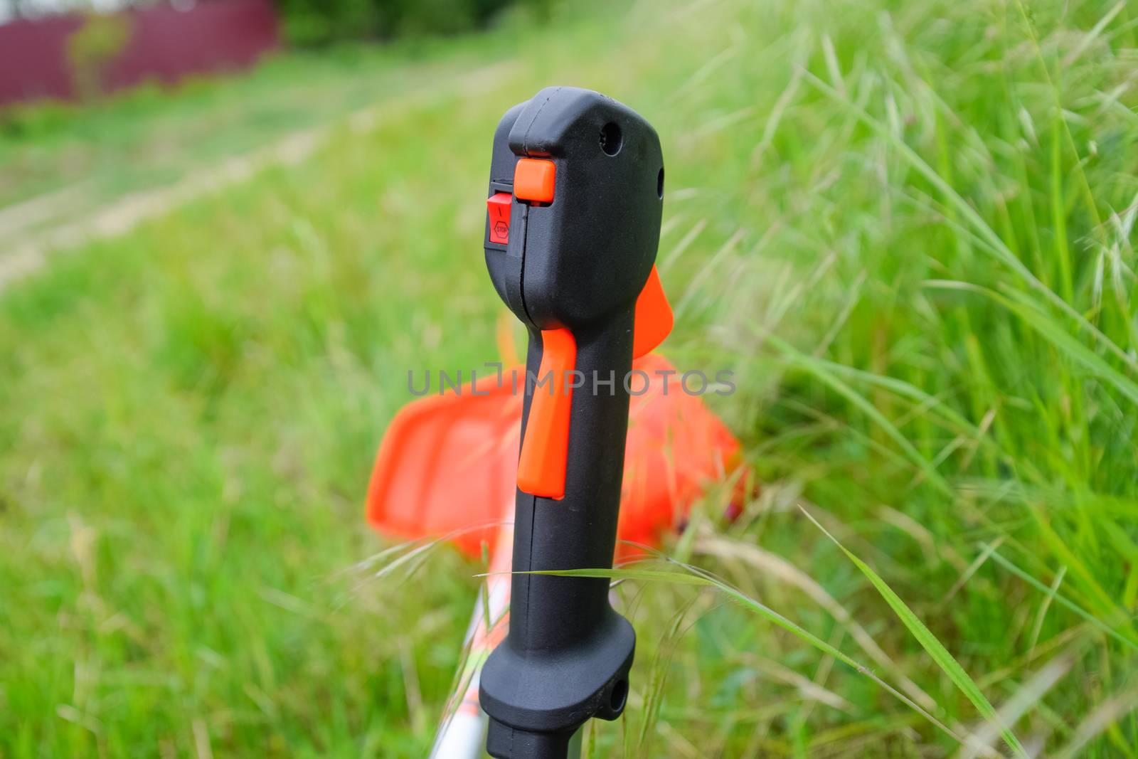 Knob with trimmer controls. Gas trimmer, equipment controls. Trimer gascosis with a leaf for mowing grass and shrubs.