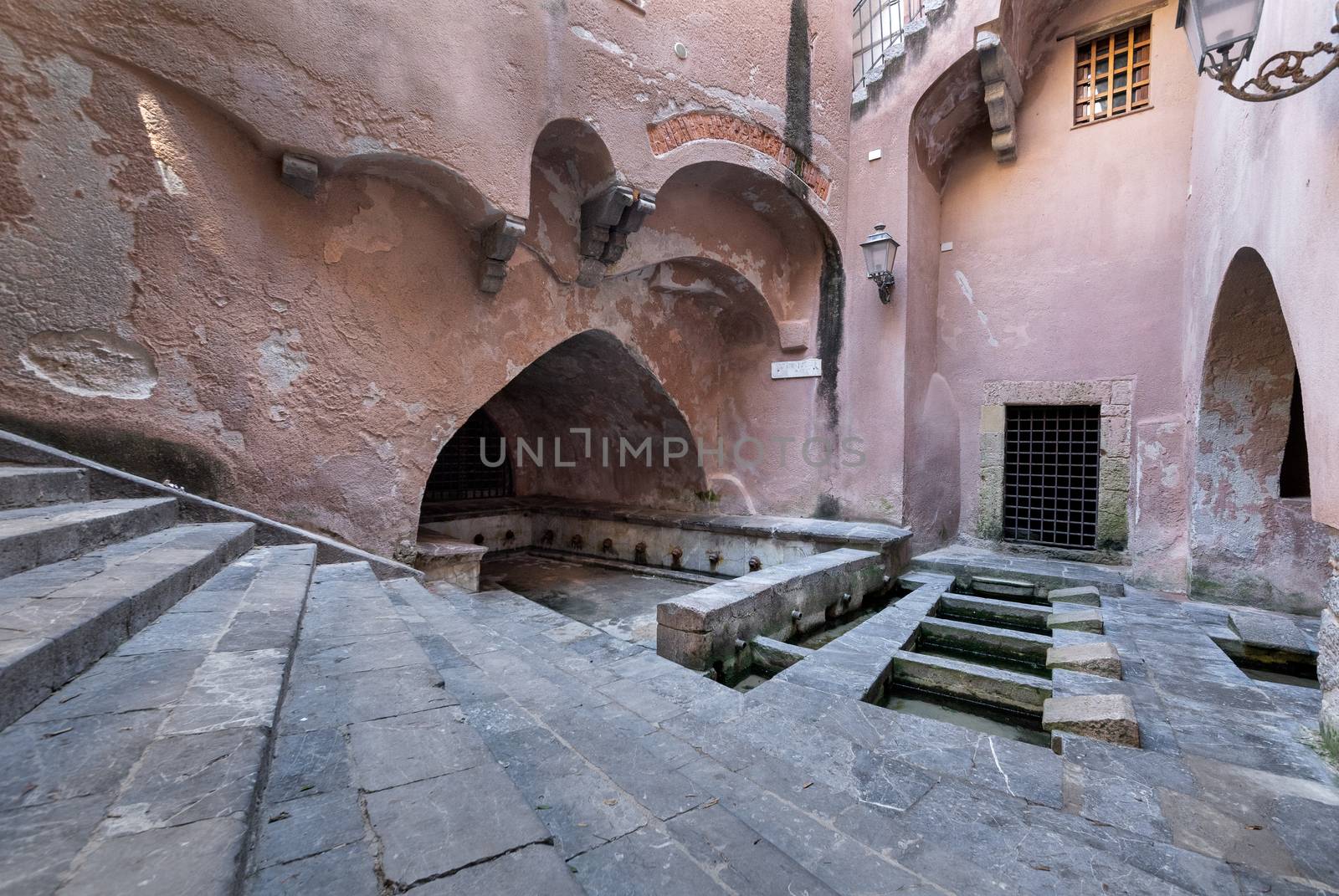 No tourists in the Lavatoio or old wash house on a Nobody in the Lavatoio or old wash house on a sunny day in Cefalu, Sicily, Southern Italy.sunny day in Cefalu, Sicily, Southern Italy. by tamas_gabor