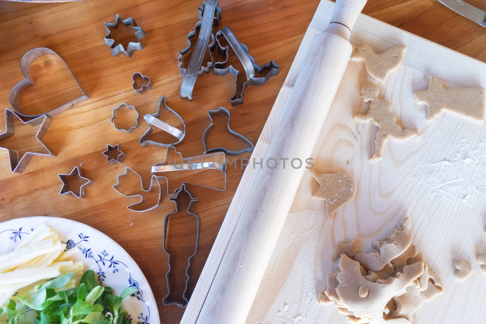 Traditional homemade gingerbread baking. Dough cut out, table flat lay view.