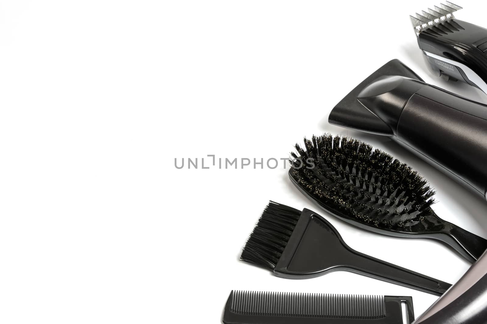 Hairdresser set with various accessories on a white background with copy space