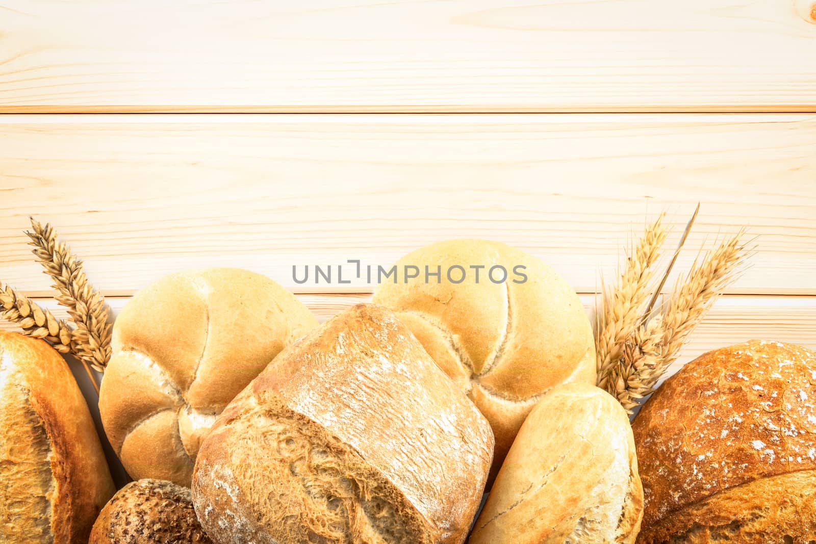 Top view of a variety fresh breads  on a wooden background with copy space.