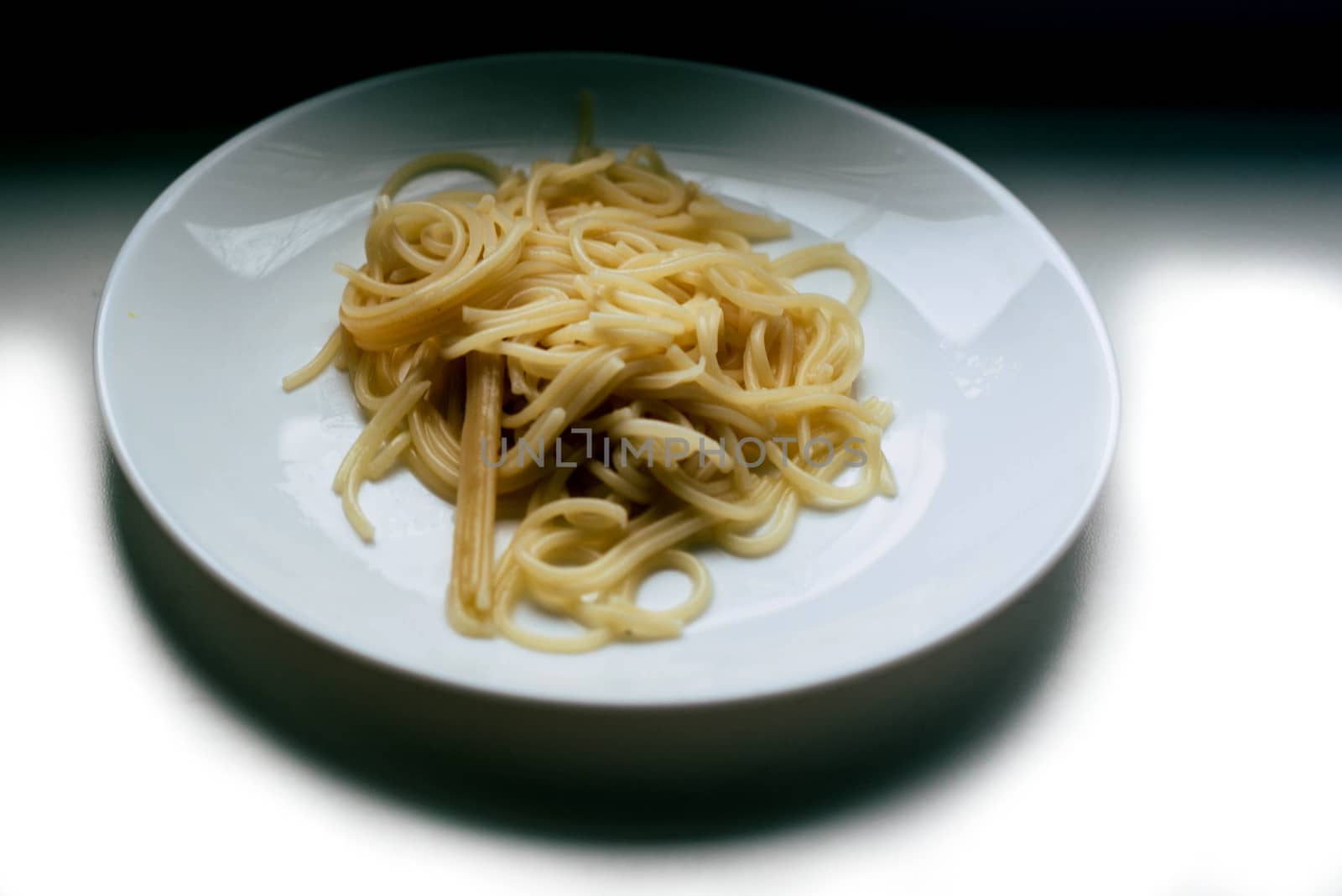 A plate of pasta on a white background