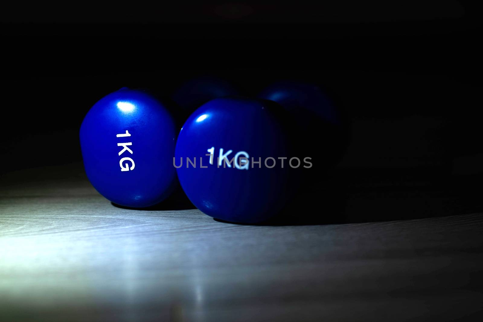 Blue dumbbells on the floor