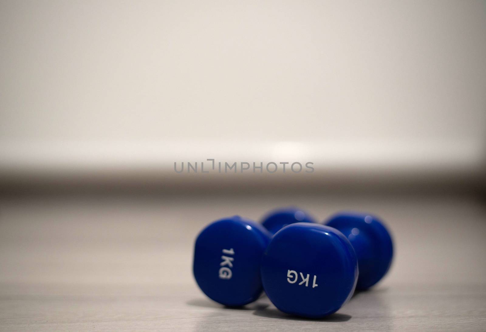 Blue dumbbells on the floor