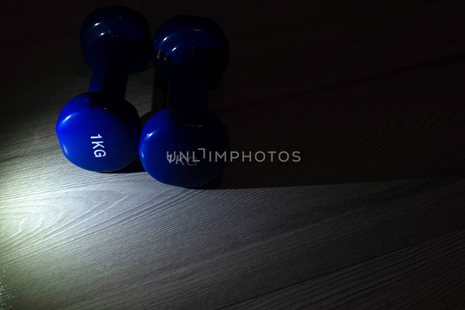 Blue dumbbells on the floor