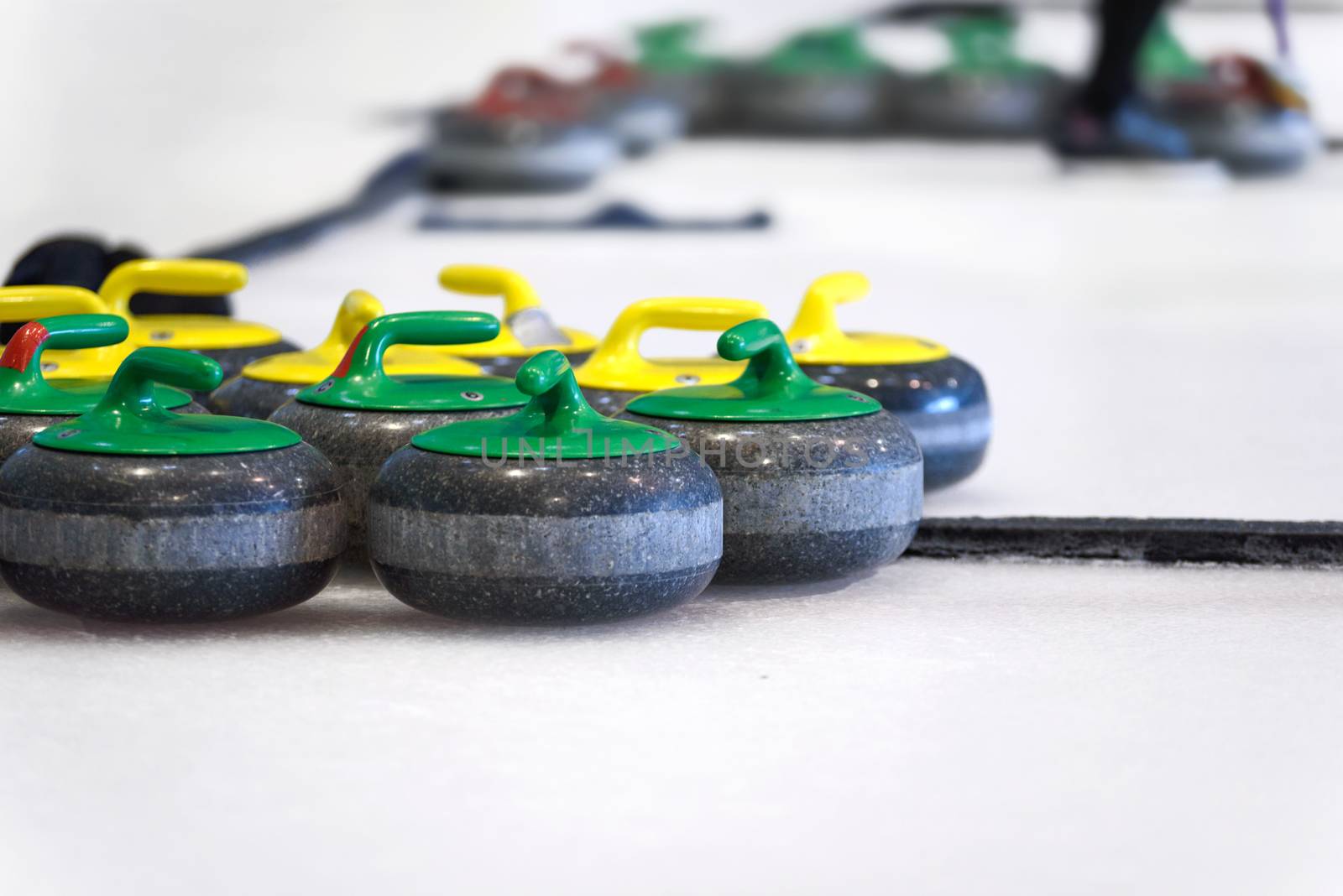 Curling stones equipment on the ice in close-up.