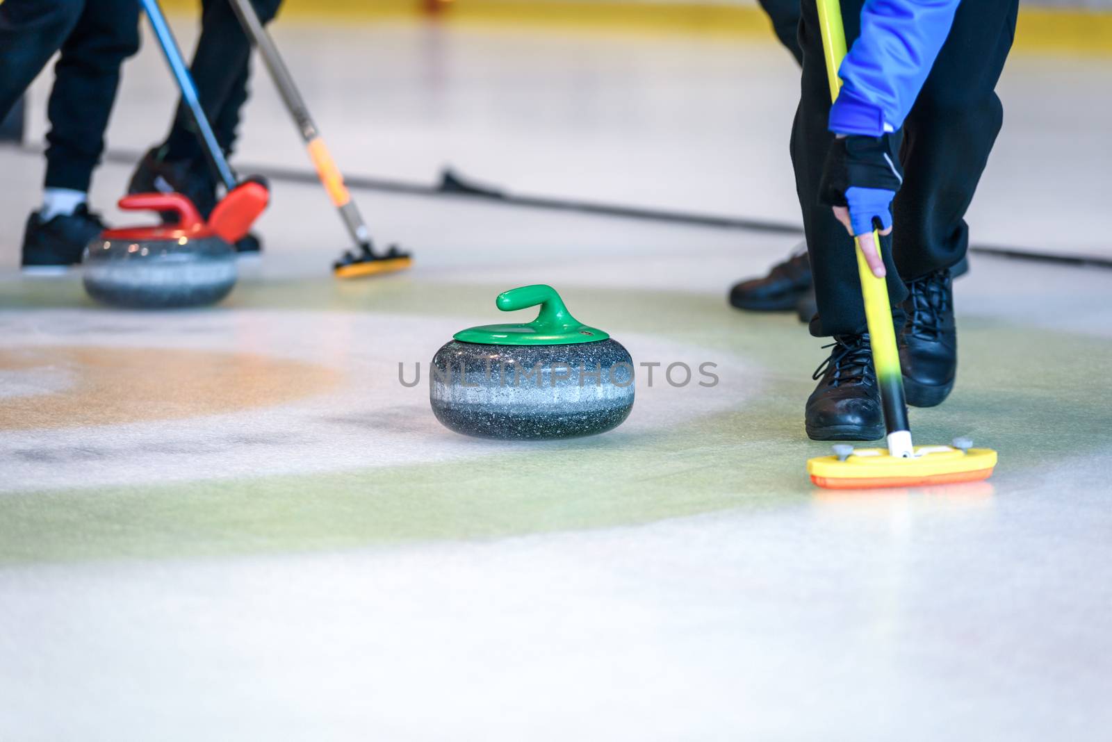 Team members play in curling at the championship.