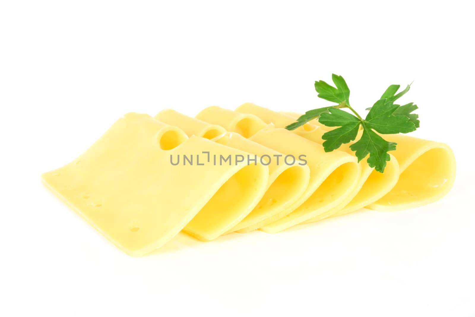 Pieces of fresh yellow cheese with parsley isolated on a white background in close-up