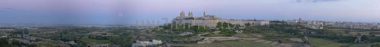 A super Moon rises over a panoramic view of the medieval city of Mdina and its surrounding countryside in Malta