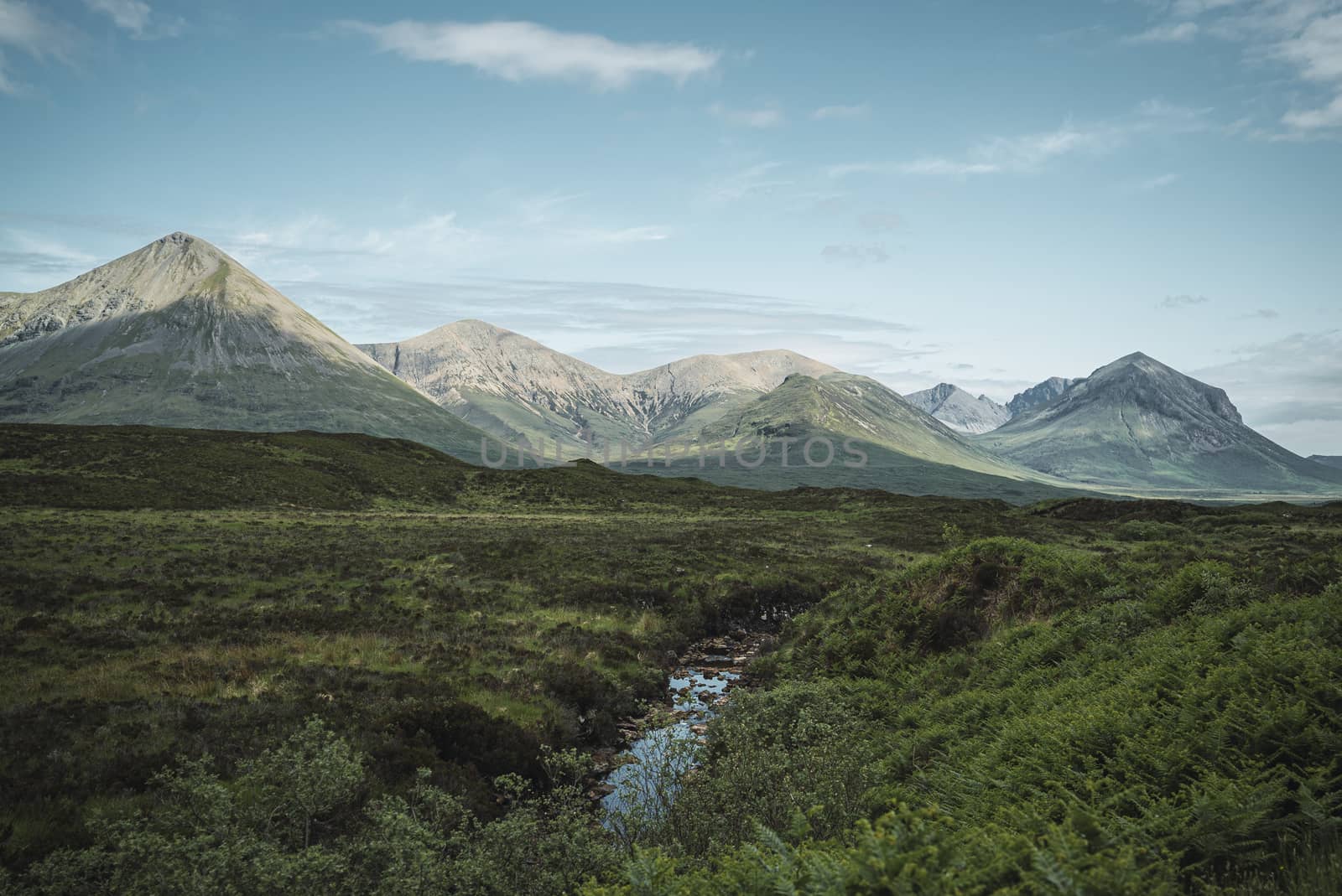 Beautiful landscape of the highlands in Scotland with mountains and a river