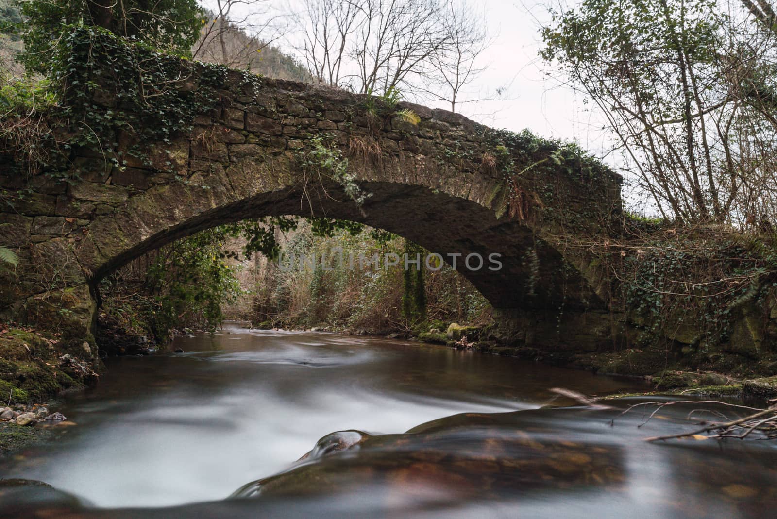 bridge with river underneath in a long exposure photo