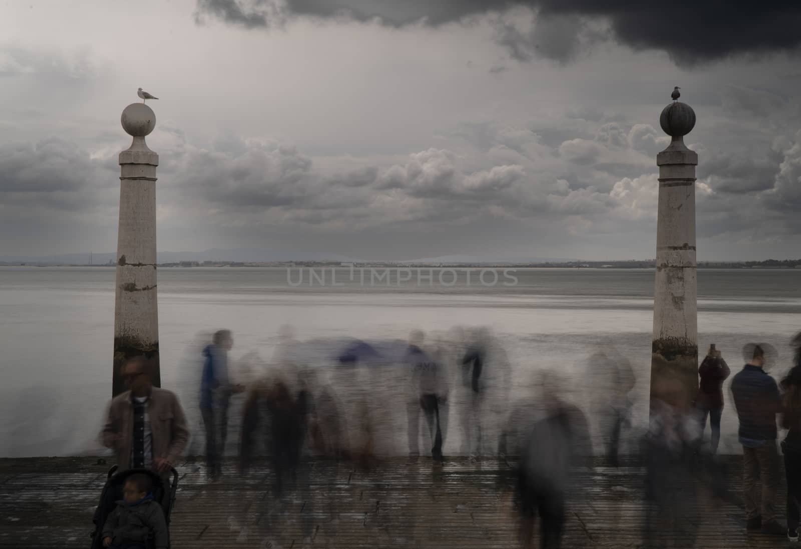 lisbon sea blurry people seagulls cloudy rainy day