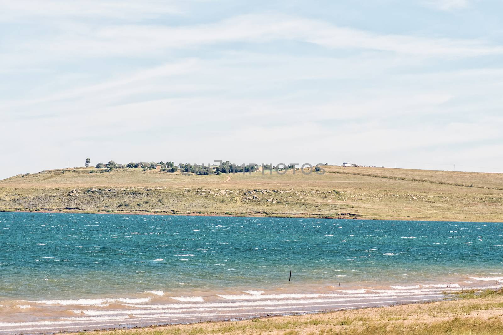 View of a stormy Sterkfontein Dam with the Sterkfontein Holiday Resort in the back