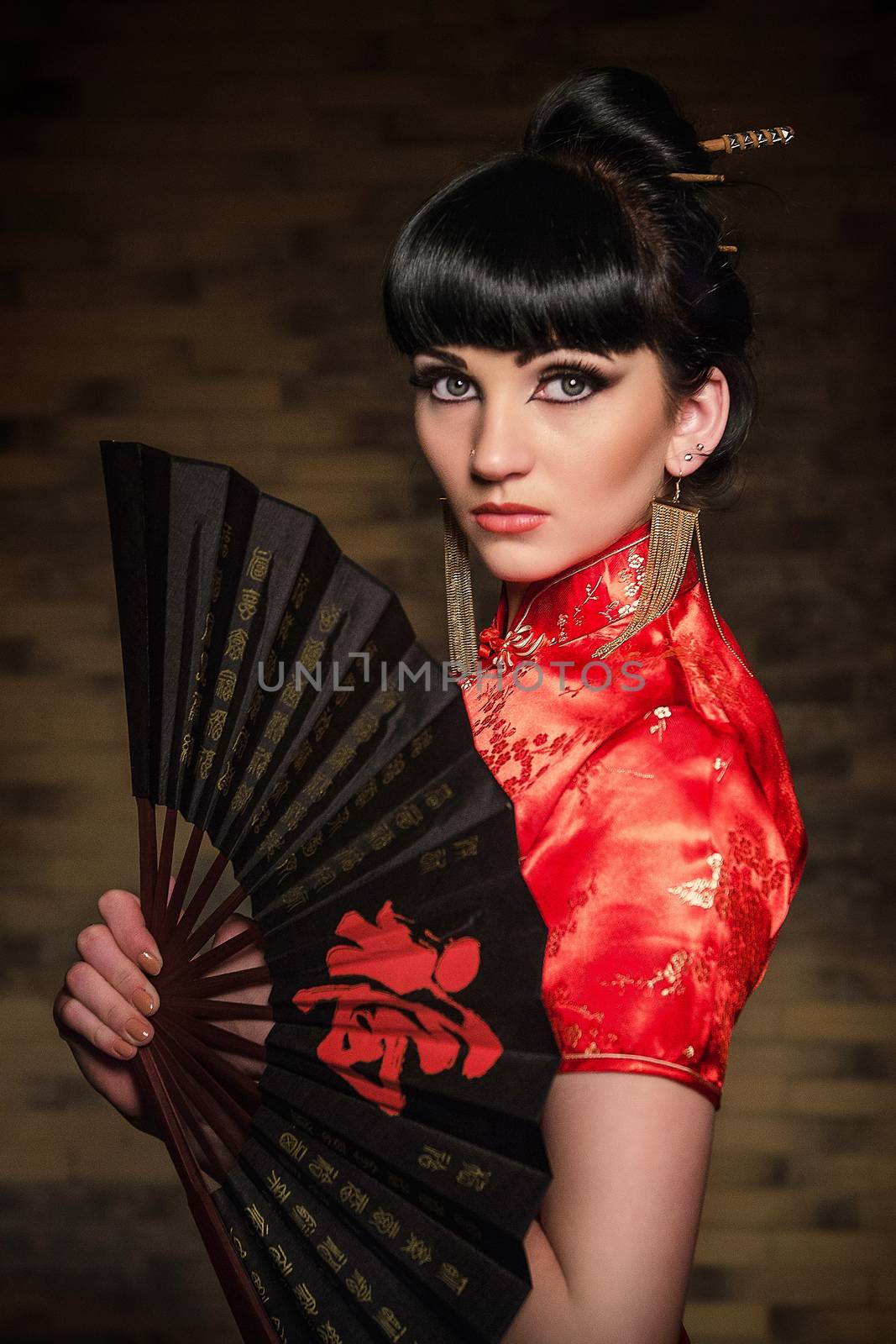 girl in a red Japanese silk dress qipao in a dark atmospheric room