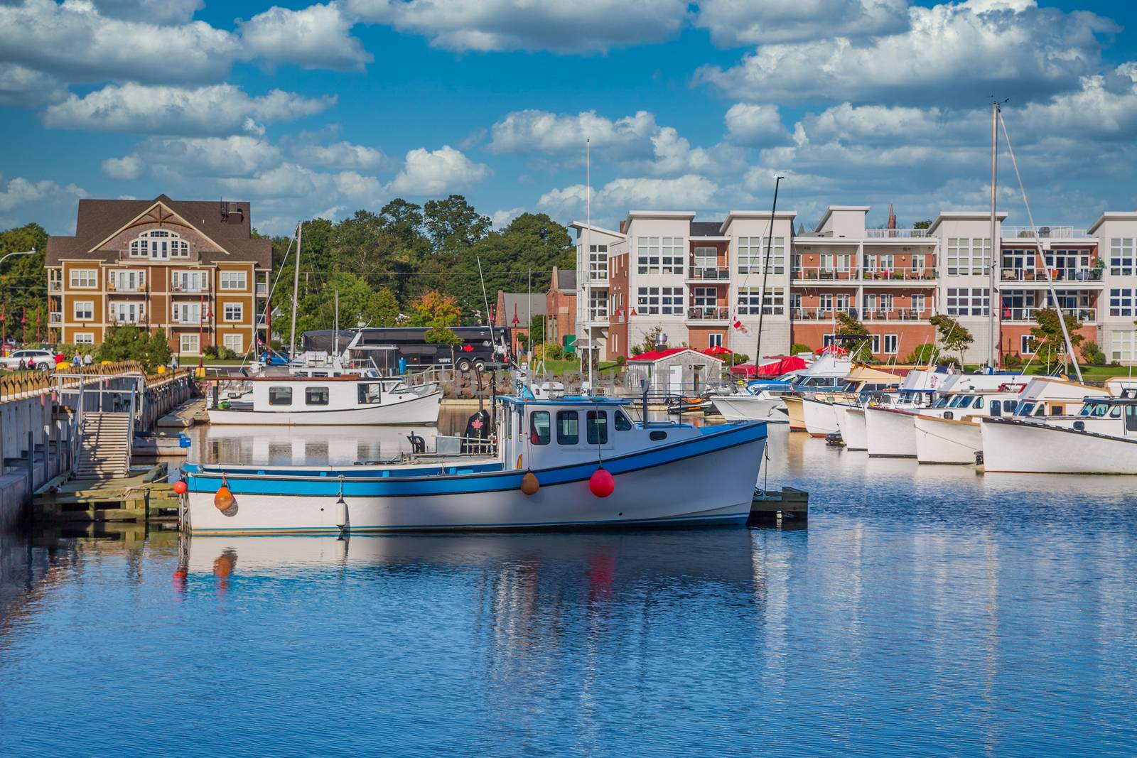 Small fishing boats in a calm blue harbor on Prince Edward Island in Canada