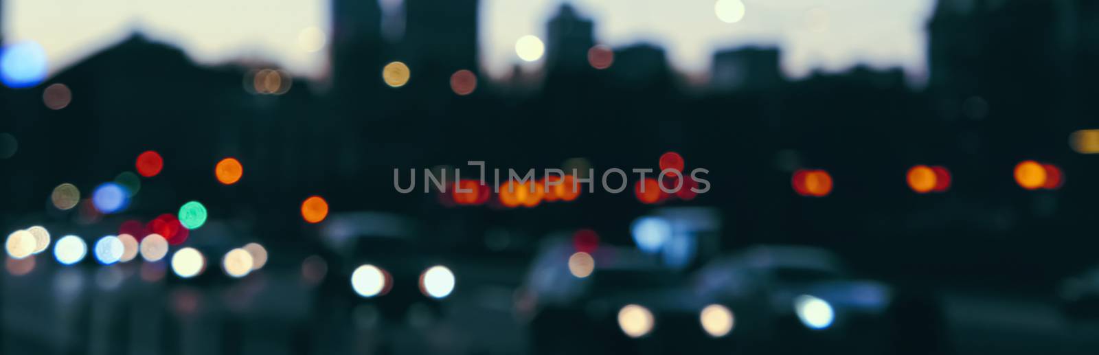 Blurry cityscape silhouette of a European city as background, evening view by Anneleven