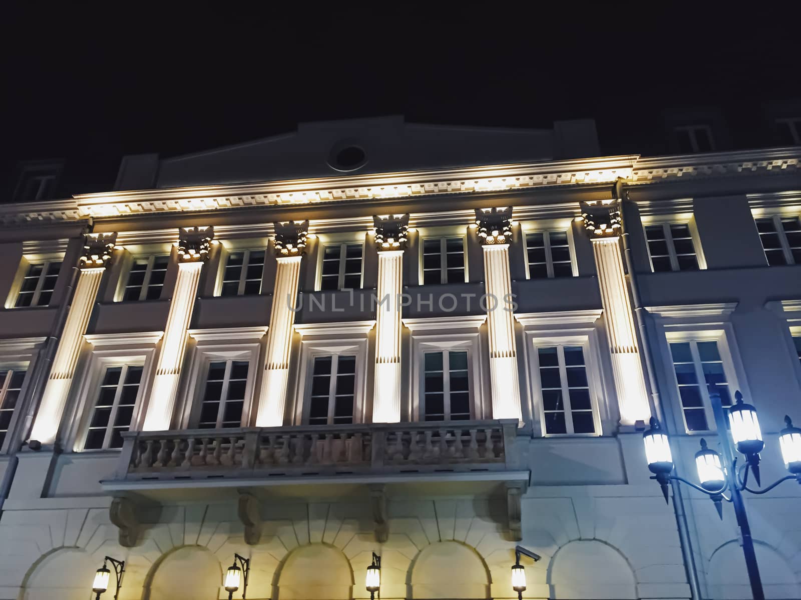 Exterior facade of classic building in the European city at night, architecture and design detail