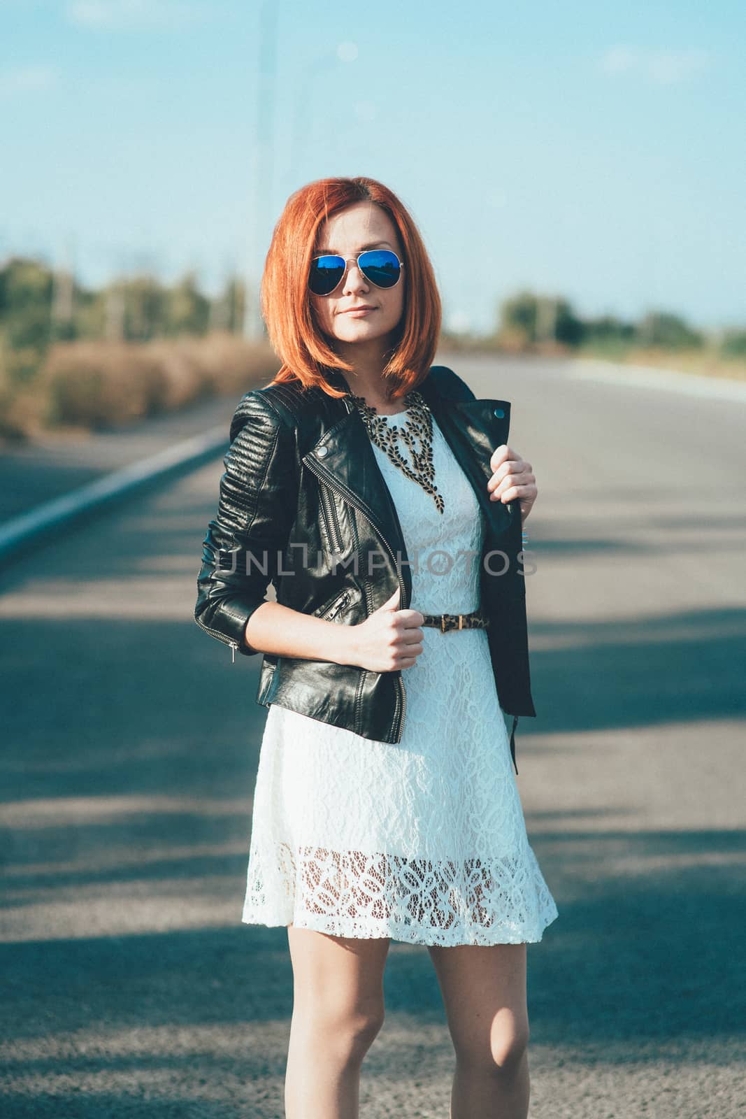 red-haired girl in a black jacket and blue glasses by Andreua