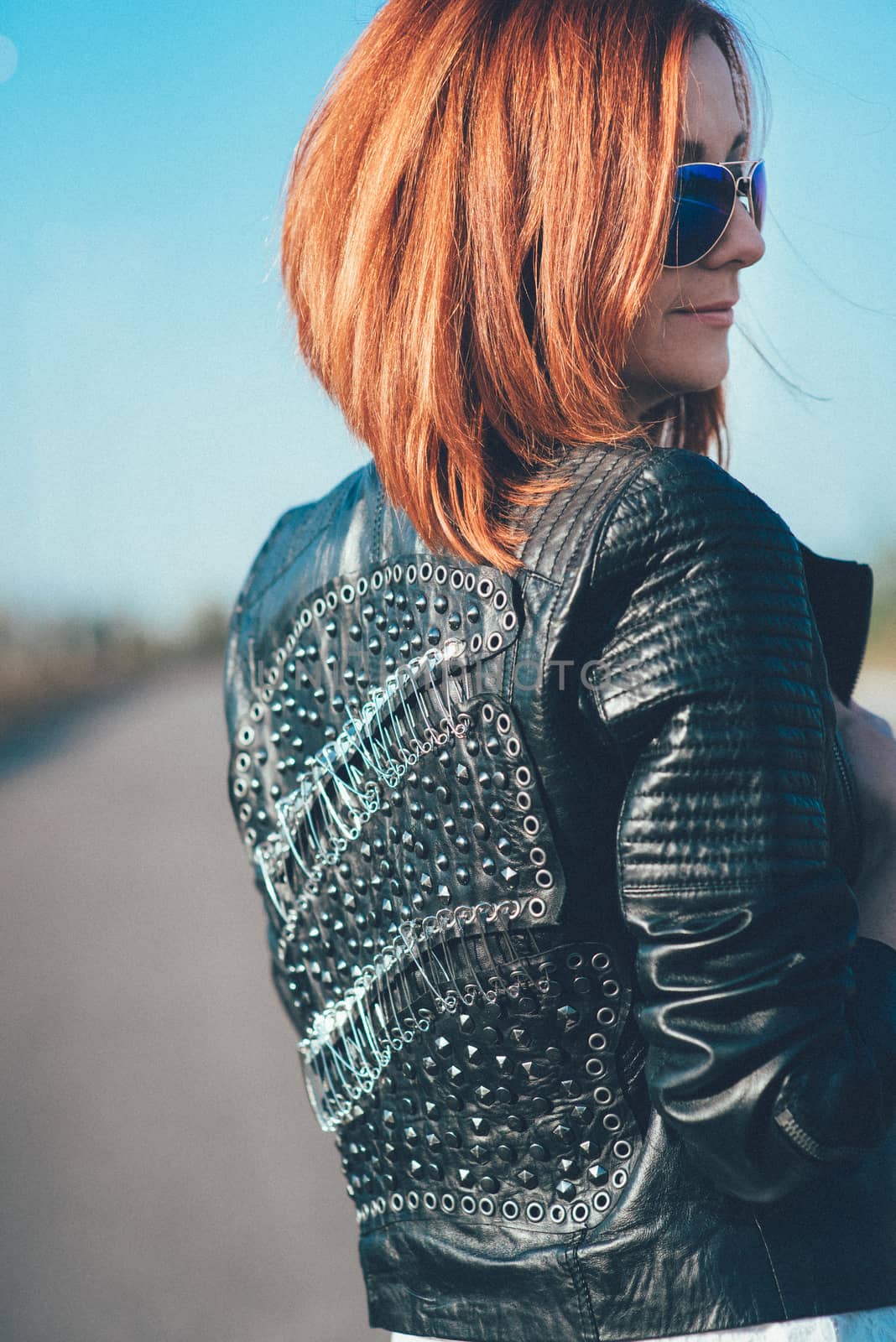 red-haired girl in a black jacket and blue glasses by Andreua