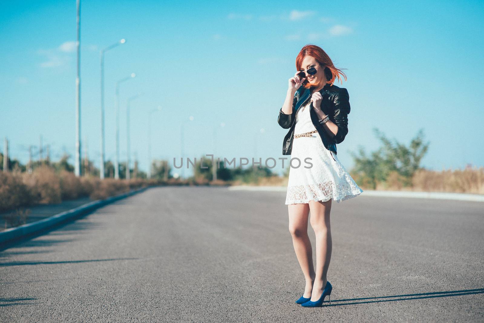 red-haired girl in a black jacket and blue glasses by Andreua