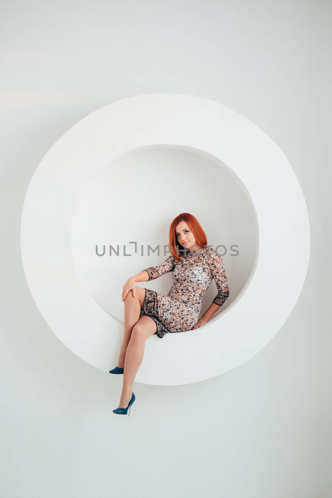 red-haired model girl with blue eyes on a white circle background