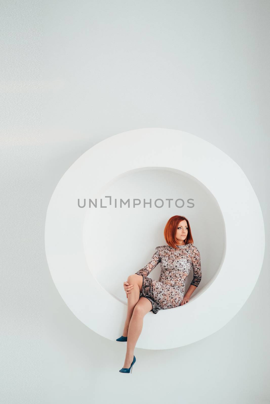 red-haired model girl with blue eyes on a white circle background