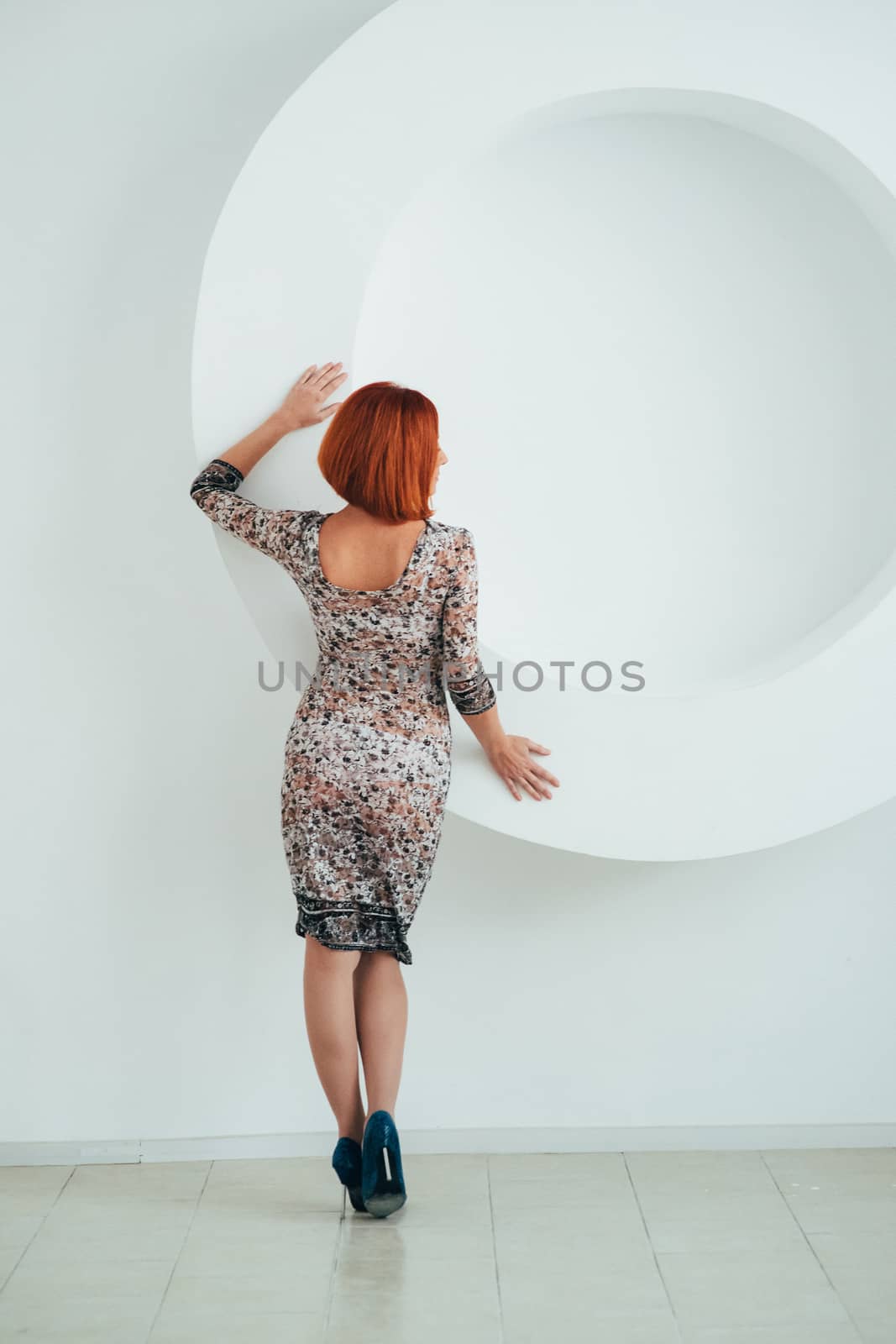 red-haired model girl with blue eyes on a white circle background