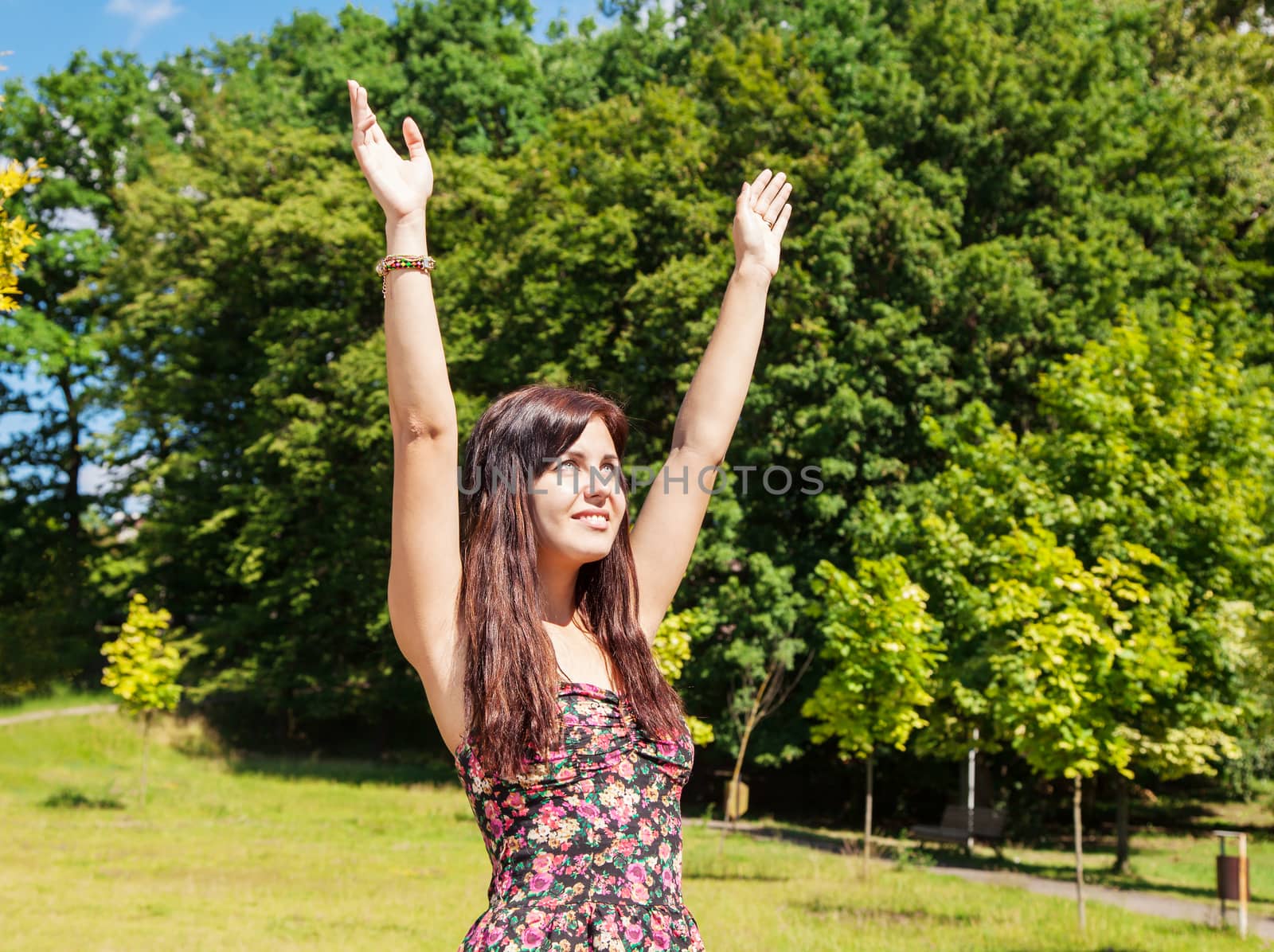 young beautiful girl enjoing sunny skies in the park