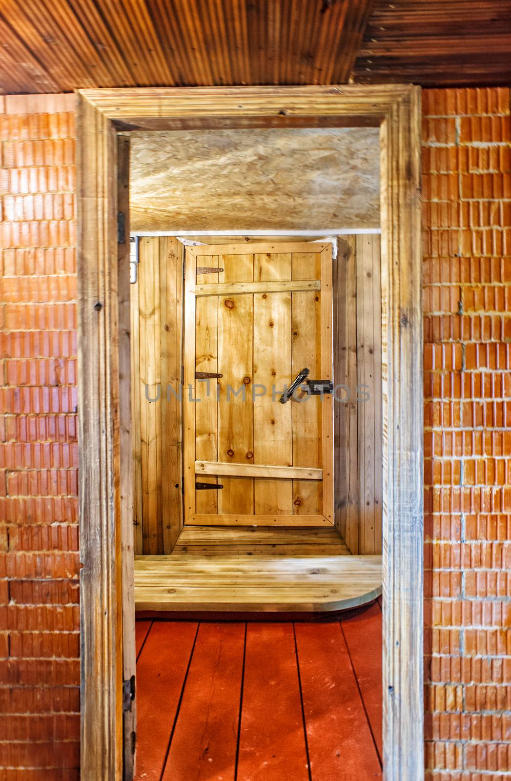 interior a rustic bath with wooden door