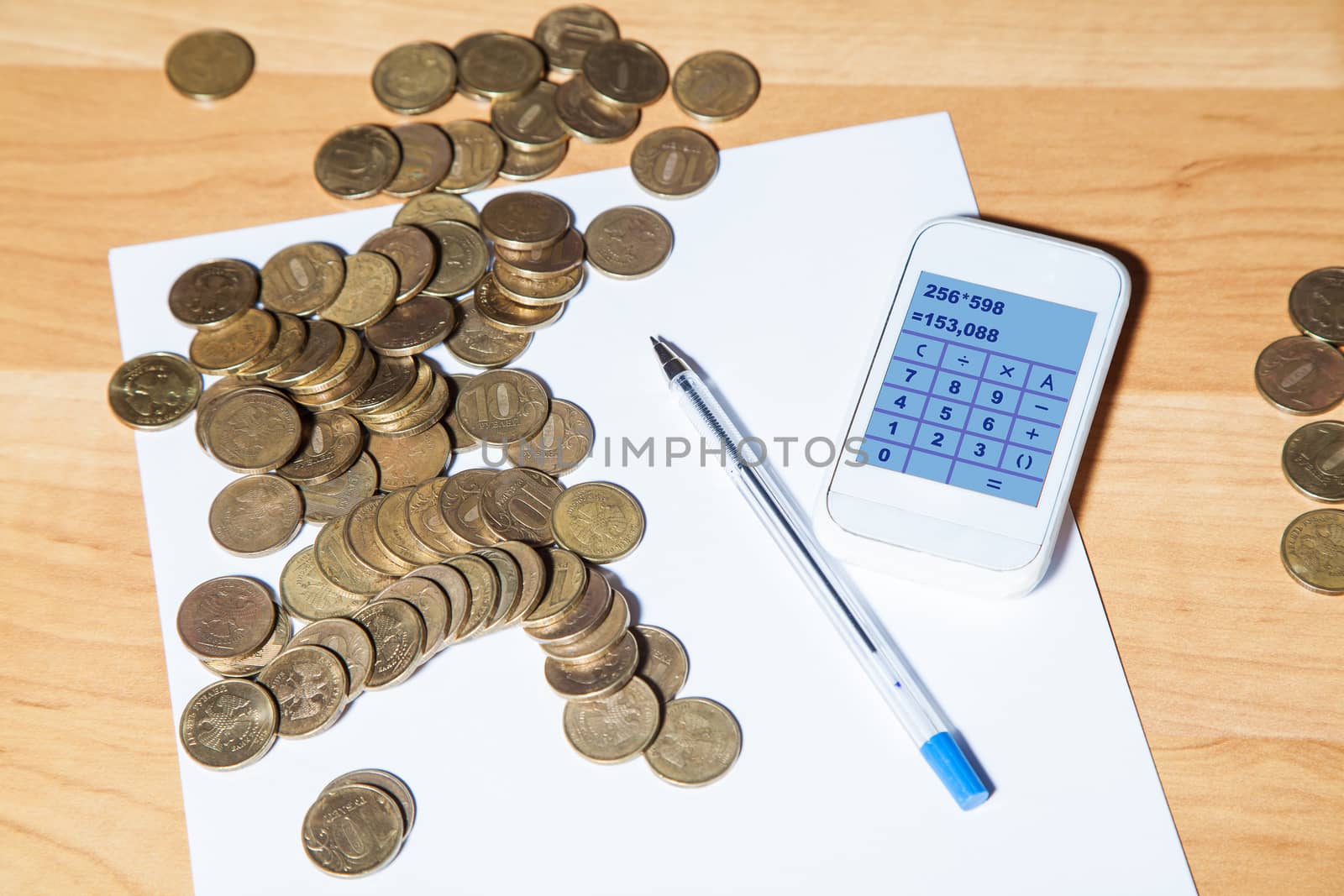 russian coins, pen, paper and a calculator on the table closeup