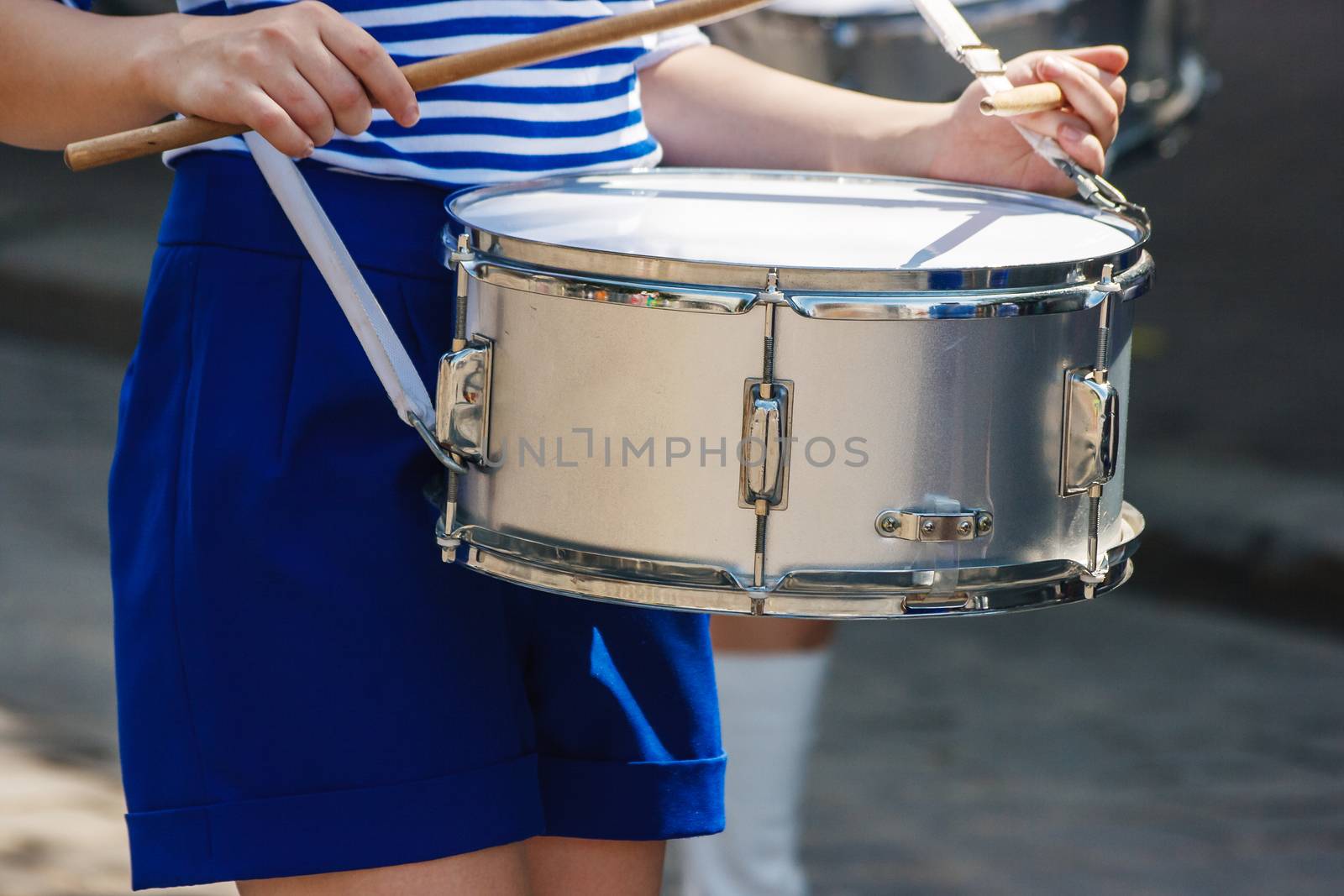 group of girls drummers. parade on a city street. body parts closeup