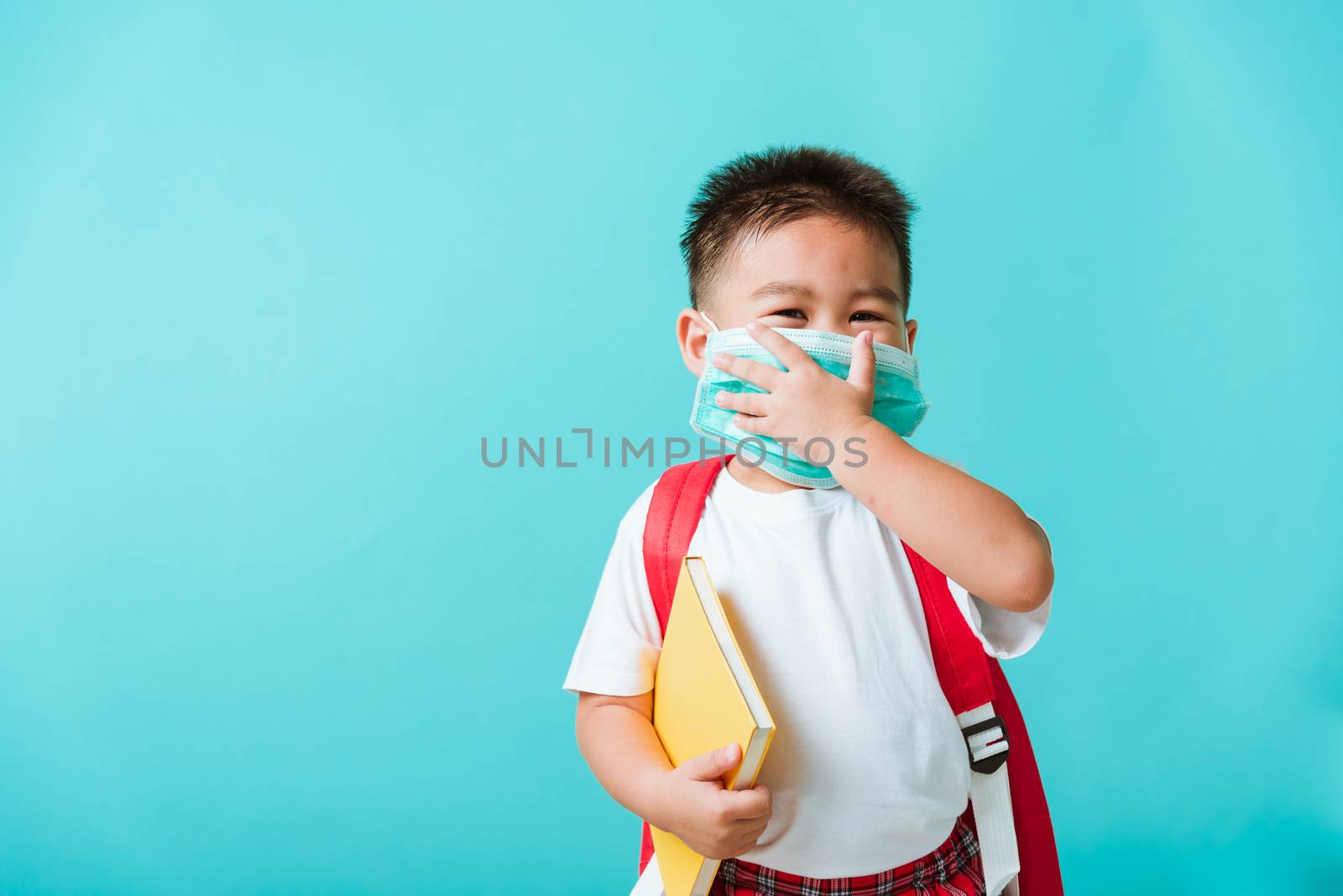 child boy kindergarten wear face mask protective and school bag  by Sorapop